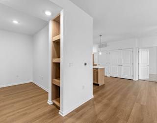 A room with a white wall and a wooden floor.