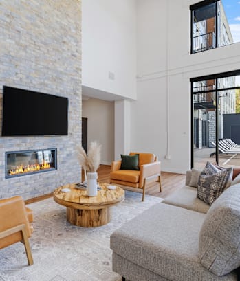 a living room with a fireplace and a tv on the wall