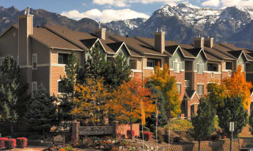 an apartment building with mountains in the background