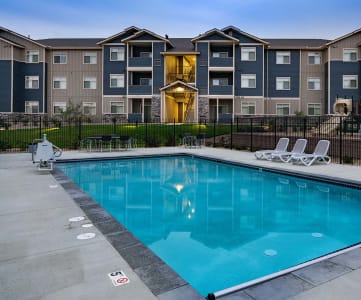 Pool with Apt building in background Copper Creek Apts For Rent | Colorado Springs, CO 80916