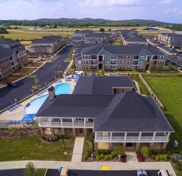 an aerial view of community with apartment buildings and a pool