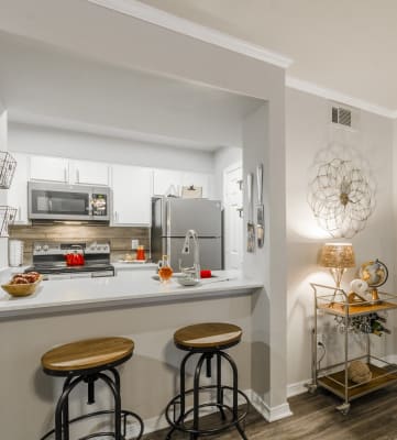 a kitchen with a breakfast bar and two stools