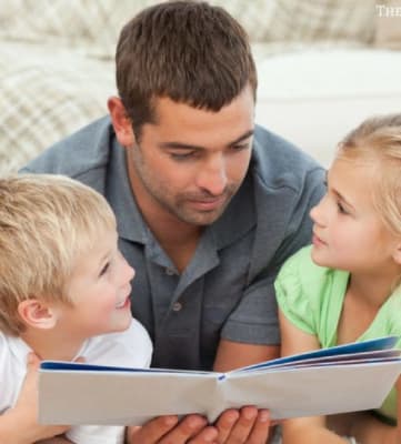 Image showing family of 4 reading a book together