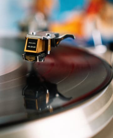 a close up of a record player on top of a stack of records