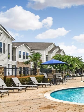 the preserve at ballantyne commons community swimming pool with lounge chairs and umbrellas