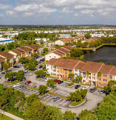 an aerial view of a row of houses next to a lake