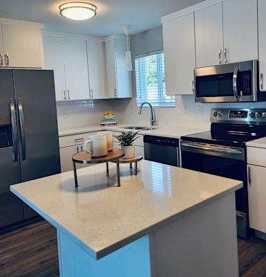 a kitchen with stainless steel appliances and white cabinets