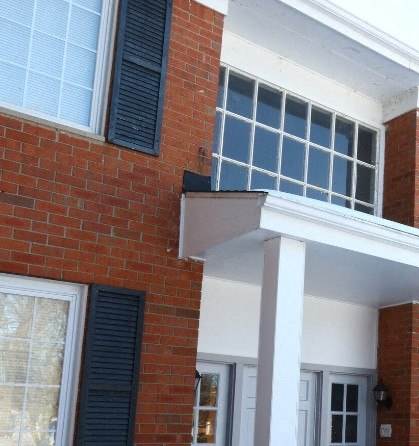 a brick building with windows and a balcony