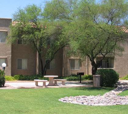 a picnic area in front of an apartment building