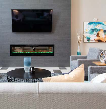 A living room with a greyat The Edison at Avonlea, Lakeville at Avonlea in Lakeville, MN