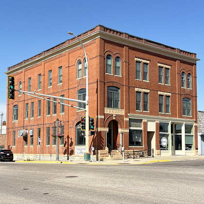 a large brick building on the corner of a city street