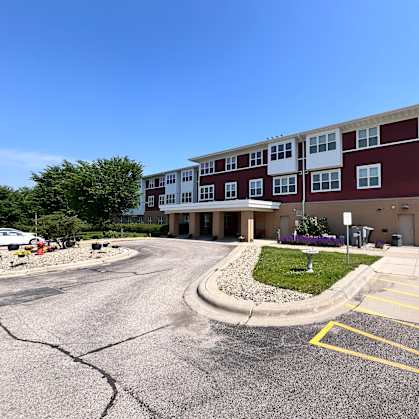 A red and white building with a parking lot in front.