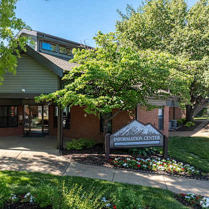 A building with a green roof and a sign that says "Information Center" in front of it.