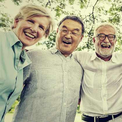 A group of five people are standing together and smiling.