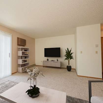 Fargo, ND Hunters Run Apartments. A living room with a tv, coffee table, and bookshelf with a large sliding glass door that brightens up the room with natural light.