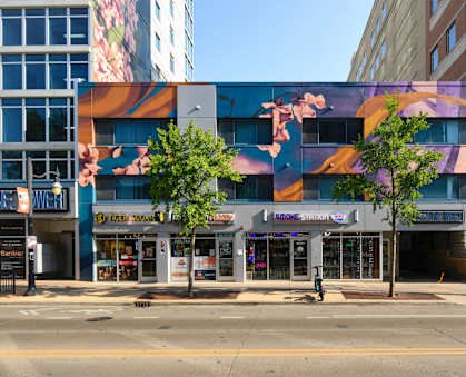 a city street with a large mural on the side of a building