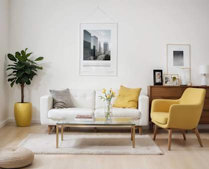 A living room with a white couch, yellow chair, and a yellow vase.