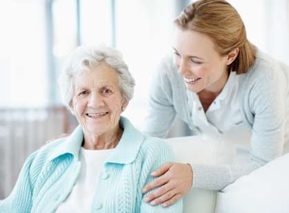 an elderly woman sitting in a hospital bed with a nurse at Tyrone, St. Petersburg, Florida
