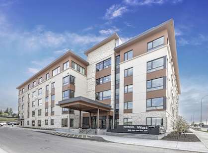 a rendering of the exterior of a building with a street in front of it