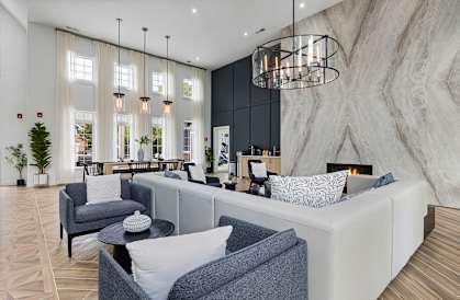 a living room with couches and chairs and a fireplace