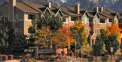 an apartment building with mountains in the background