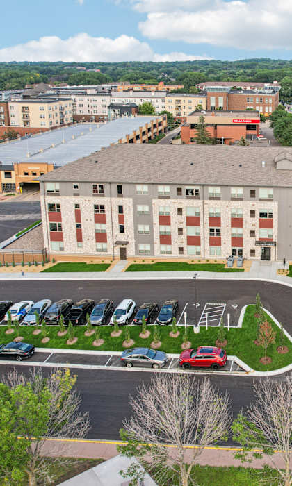 A large building with a parking lot in front of it.