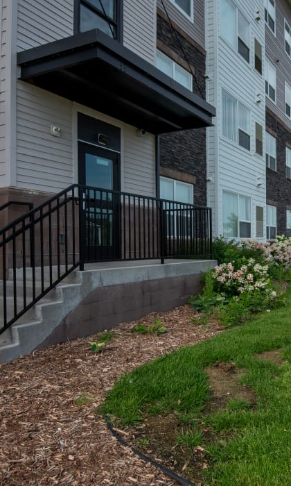 an apartment building with a sidewalk in front of it
