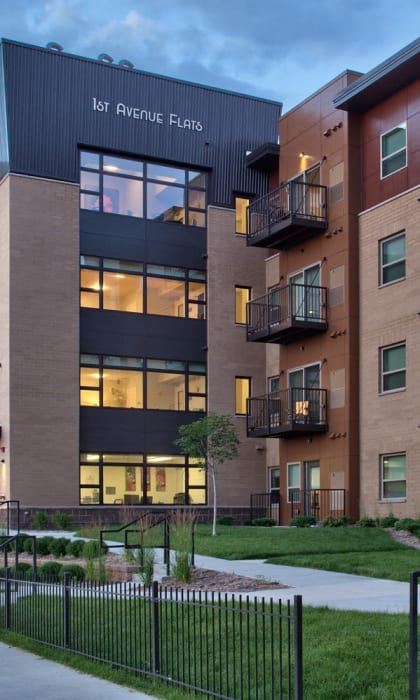 an exterior view of an apartment building at dusk