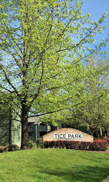 A sign that says Tice Park in front of a building.