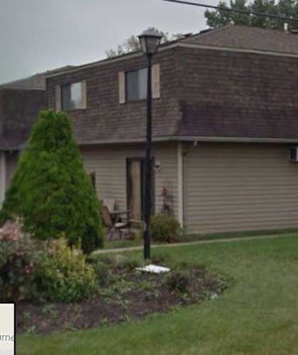 a house with a red door and a yard