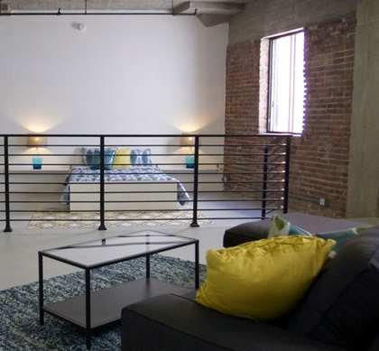 a living room with a couch and a table at Binford Lofts Apartments, California