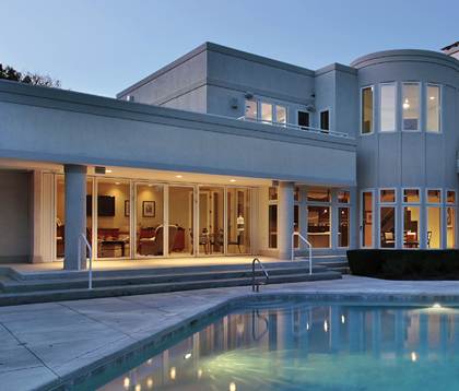 A modern house with a pool in the backyard.