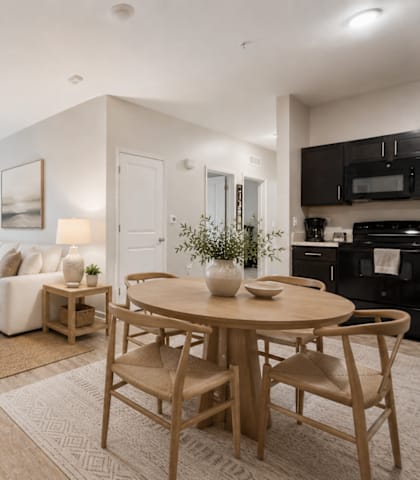 A well-lit, modern living room with a dining area.
