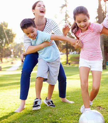 Family of four playing soccer