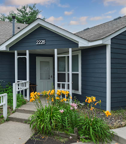 A blue house with the number 2226 on the front door.