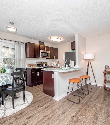 Open floor plan dining room kitchen large window living room at Brittany Place Apartments in Norfolk VA