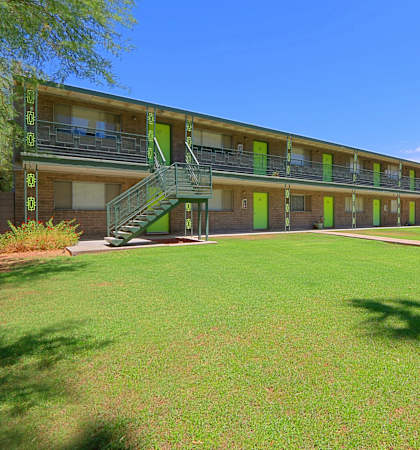 a large green lawn in front of a building