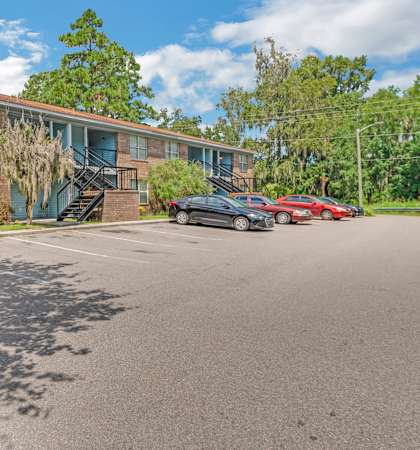 a brick building with cars parked in front of it