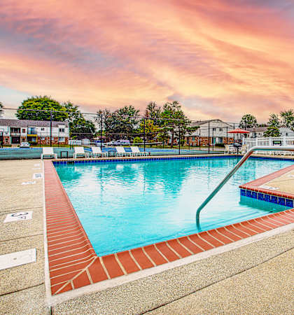 A swimming pool surrounded by a red brick border.