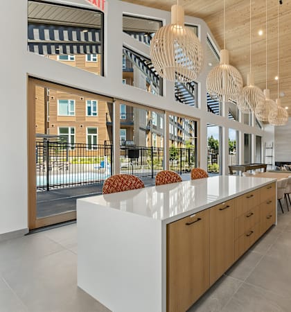 A modern kitchen with wooden cabinets and a white countertop.
