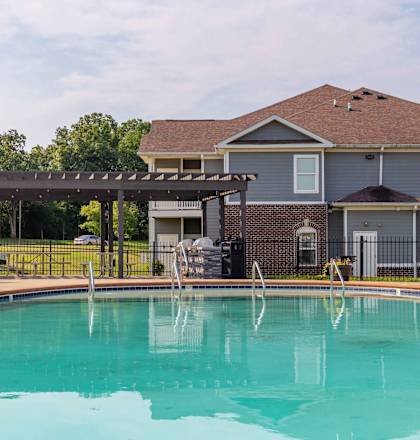a swimming pool with a large house in the background