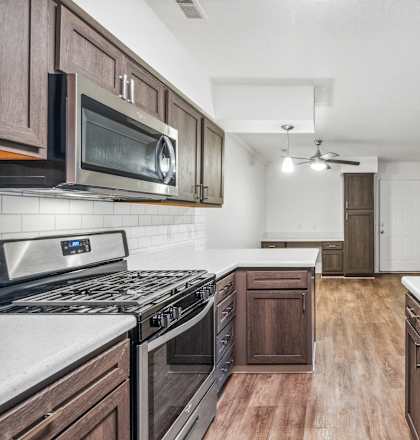 a kitchen with wooden cabinets and stainless steel appliances