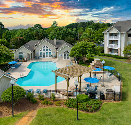 Aerial of swimming pool, exteriors of buildings and clubhouse