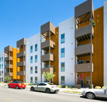 Apartments exterior white grey orange paint streetside