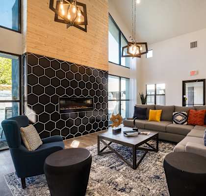a living room with couches and chairs and a fireplace