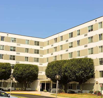 picture of a large building with an american flag in front of it