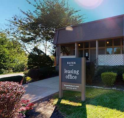 a leasing office sign in front of a house