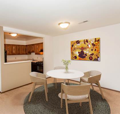 a dining room with a table and chairs and a kitchen