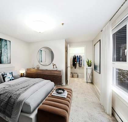 a bedroom with a large bed and a large window