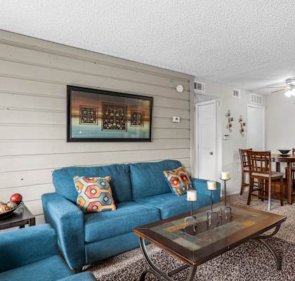 a living room with a blue couch and a coffee table